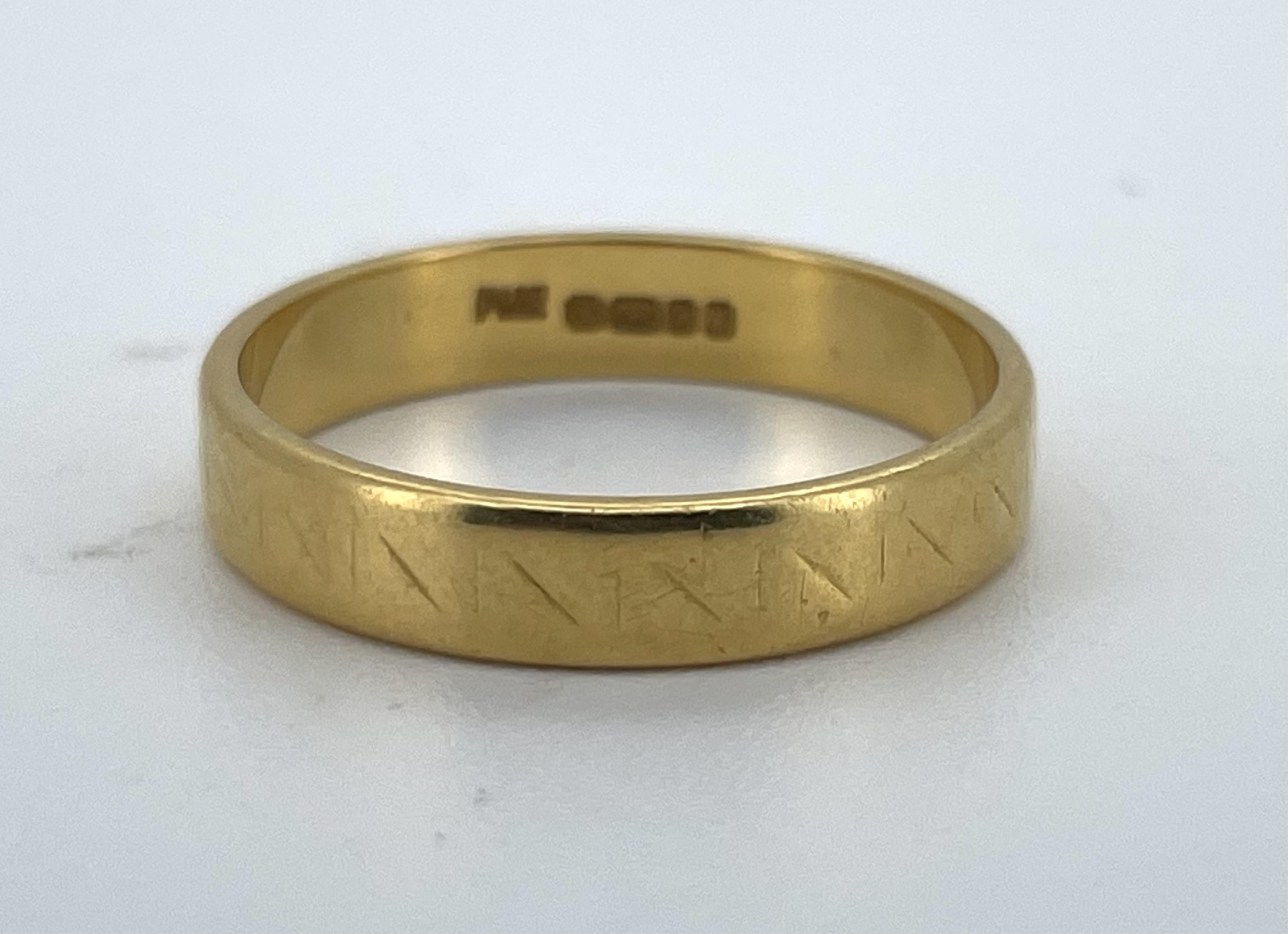 A 22ct gold wedding band, with geometric decoration, size O, 4mm width, British hallmarks, date letter for 1963, gross weight approximately 4 grams